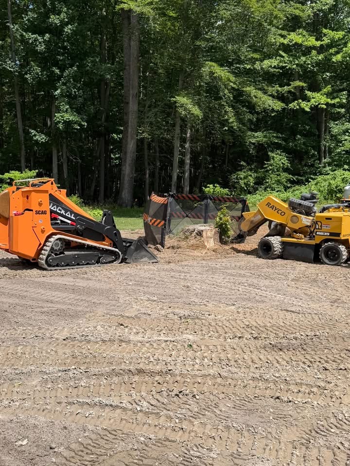 Stump grinding machine removing a large tree stump in a residential yard in York County, Maine