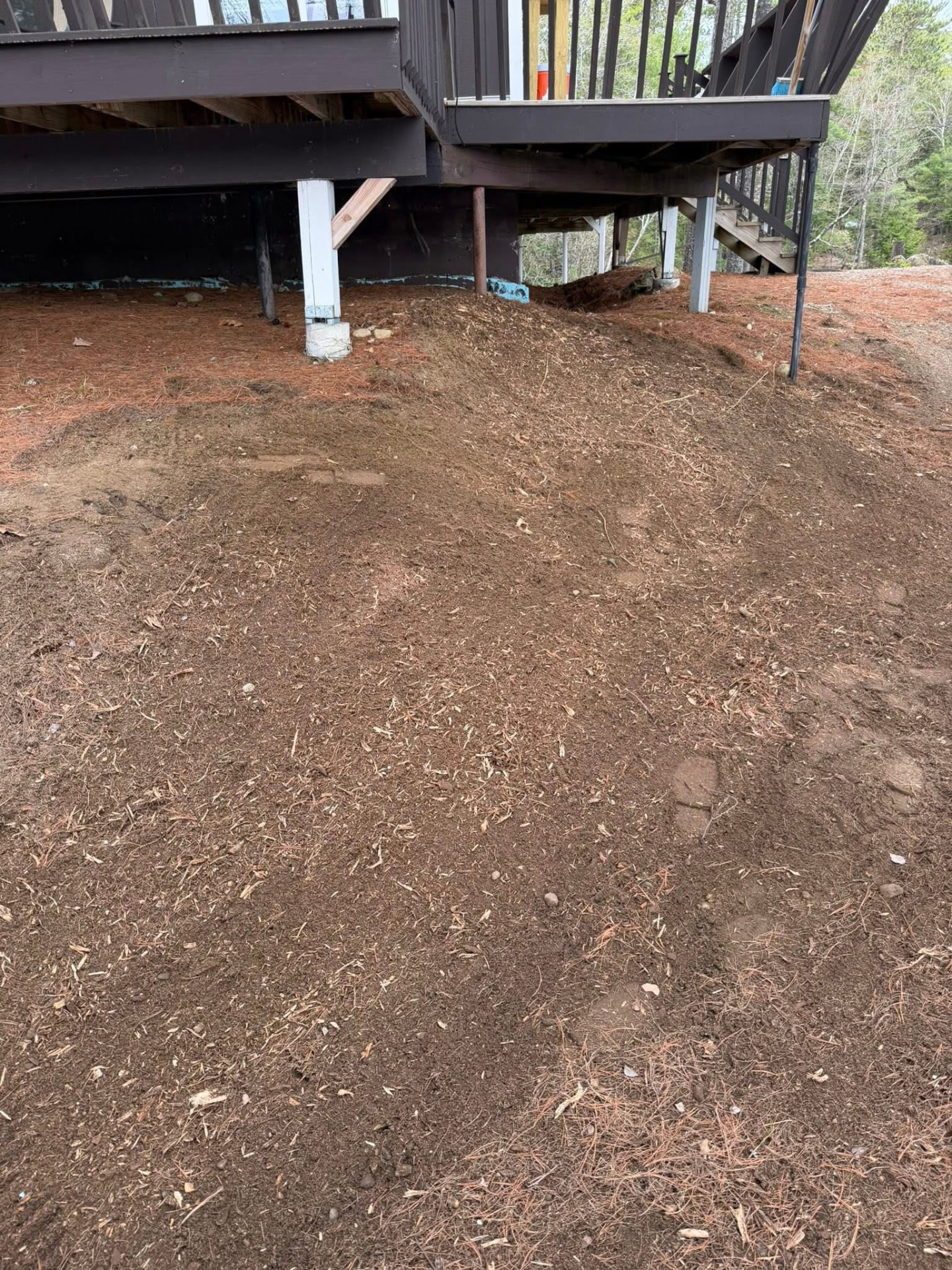 Area under the deck graded smooth after stump grinding
